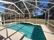 Refreshing screened pool with clear water, surrounded by lush greenery at 11105 Sw 69Th Cir, Ocala, FL 34476