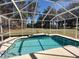 Inviting screened pool with surrounding lush landscape and open space at 11105 Sw 69Th Cir, Ocala, FL 34476