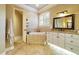 Bathroom with corner bathtub, granite vanity, and tile flooring at 1219 Se 46Th St, Ocala, FL 34480