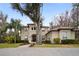 Two-story house with a tile roof, arched entryway and landscaped yard at 1219 Se 46Th St, Ocala, FL 34480