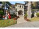 Two-story house with a tile roof, arched entryway and landscaped yard at 1219 Se 46Th St, Ocala, FL 34480