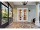 French doors leading to a screened patio with brick pavers at 1219 Se 46Th St, Ocala, FL 34480