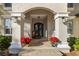 Elegant front porch with arched entryway, rocking chairs, and poinsettias at 1219 Se 46Th St, Ocala, FL 34480