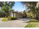 Three-car garage with paver driveway and nicely landscaped surroundings at 1219 Se 46Th St, Ocala, FL 34480