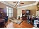 Home office with wood desk, built-in shelving, and hardwood floors at 1219 Se 46Th St, Ocala, FL 34480