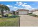 Single-story house with attached garage, and a well-manicured lawn at 12498 Se 92Nd Ave, Summerfield, FL 34491