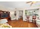 Living room with hardwood floors, and a view into the kitchen at 12498 Se 92Nd Ave, Summerfield, FL 34491