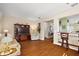 Living room with hardwood floors, comfortable seating, and built-in entertainment center at 12498 Se 92Nd Ave, Summerfield, FL 34491