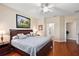 Main bedroom with wood floors and access to the bathroom at 12498 Se 92Nd Ave, Summerfield, FL 34491