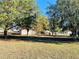 Large backyard with mature trees and outbuildings at 15000 Sw 27Th Ln, Ocala, FL 34481