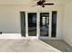 White back patio with glass doors leading inside at 1846 Ne 127Th Pl, Anthony, FL 32617