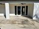 White back patio with glass doors leading inside at 1846 Ne 127Th Pl, Anthony, FL 32617