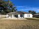 House with grassy backyard and white fence at 1846 Ne 127Th Pl, Anthony, FL 32617