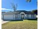 A newly constructed home with a white exterior, dark accents, and a well-manicured lawn at 1846 Ne 127Th Pl, Anthony, FL 32617