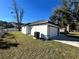 The home's garage, featuring a white exterior and a neatly landscaped yard at 1846 Ne 127Th Pl, Anthony, FL 32617