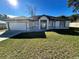 One-story house with attached garage and manicured lawn at 1846 Ne 127Th Pl, Anthony, FL 32617