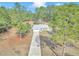 House nestled in a wooded area with a long driveway at 20189 Sw 77Th St, Dunnellon, FL 34431