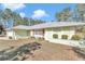 Light green house with red accents and landscaping at 20189 Sw 77Th St, Dunnellon, FL 34431