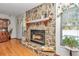 Cozy stone fireplace with wood mantle in living room at 20189 Sw 77Th St, Dunnellon, FL 34431