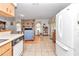 Kitchen offers a view into the living room with a stone fireplace at 20189 Sw 77Th St, Dunnellon, FL 34431