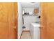 Bright laundry room with washer, dryer, and shelving at 20189 Sw 77Th St, Dunnellon, FL 34431