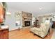 Living room with stone fireplace and hardwood floors at 20189 Sw 77Th St, Dunnellon, FL 34431