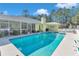 Large swimming pool in backyard with surrounding trees at 20189 Sw 77Th St, Dunnellon, FL 34431