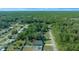 Aerial view of a house and surrounding neighborhood, showcasing the property's location and landscape at 21654 Sw Honeysuckle St, Dunnellon, FL 34431