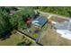 Aerial view of the house and backyard, highlighting the fenced-in play area at 21654 Sw Honeysuckle St, Dunnellon, FL 34431