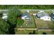 Aerial view of the house and backyard, showing the fenced play area and screened porch at 21654 Sw Honeysuckle St, Dunnellon, FL 34431