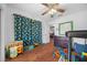 bedroom with dinosaur curtains and hardwood floors at 21654 Sw Honeysuckle St, Dunnellon, FL 34431