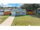 Cute light blue house with a fenced yard and driveway at 21654 Sw Honeysuckle St, Dunnellon, FL 34431