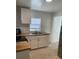 Clean and bright kitchen with white cabinets and butcher block countertops at 2211 Sw 1St St, Ocala, FL 34475