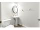 Small half bathroom with pedestal sink and oval mirror at 231 Ne 28Th Ave # 204, Ocala, FL 34470