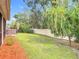 Landscaped backyard with hot tub and privacy fence at 2457 Bulrush Dr, Saint Cloud, FL 34769