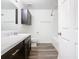 Bathroom with dark vanity, marble countertop, and tub at 2457 Bulrush Dr, Saint Cloud, FL 34769