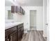 Bathroom with dark wood cabinets, double vanity, and linen closet at 2457 Bulrush Dr, Saint Cloud, FL 34769