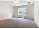 Bright bedroom with grey carpet and large window at 2457 Bulrush Dr, Saint Cloud, FL 34769