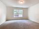 Bright bedroom with grey carpet and large window at 2457 Bulrush Dr, Saint Cloud, FL 34769