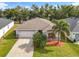 One-story home with a two-car garage and landscaped lawn at 2457 Bulrush Dr, Saint Cloud, FL 34769