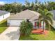 Attractive one-story house with a palm tree and well-maintained lawn at 2457 Bulrush Dr, Saint Cloud, FL 34769