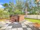 Relaxing hot tub with stone patio and umbrella at 2457 Bulrush Dr, Saint Cloud, FL 34769