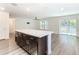 Modern kitchen island with white countertop and dark wood cabinets at 2457 Bulrush Dr, Saint Cloud, FL 34769