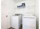 Bright laundry room with washer, dryer, and storage shelves at 2457 Bulrush Dr, Saint Cloud, FL 34769