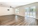 Open living space with wood-look floors and access to patio at 2457 Bulrush Dr, Saint Cloud, FL 34769