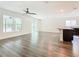 Open living area with kitchen island, wood-look floors, and ceiling fan at 2457 Bulrush Dr, Saint Cloud, FL 34769