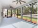 Screened porch with ceiling fan and view of backyard at 2457 Bulrush Dr, Saint Cloud, FL 34769