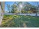 Sunny backyard with a large grassy area and a privacy fence at 3914 Ne 58Th Cir, Silver Springs, FL 34488