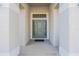 Inviting entryway with a modern door and neutral color palette at 3914 Ne 58Th Cir, Silver Springs, FL 34488