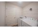 Laundry room with washer, dryer, and shelving at 3914 Ne 58Th Cir, Silver Springs, FL 34488